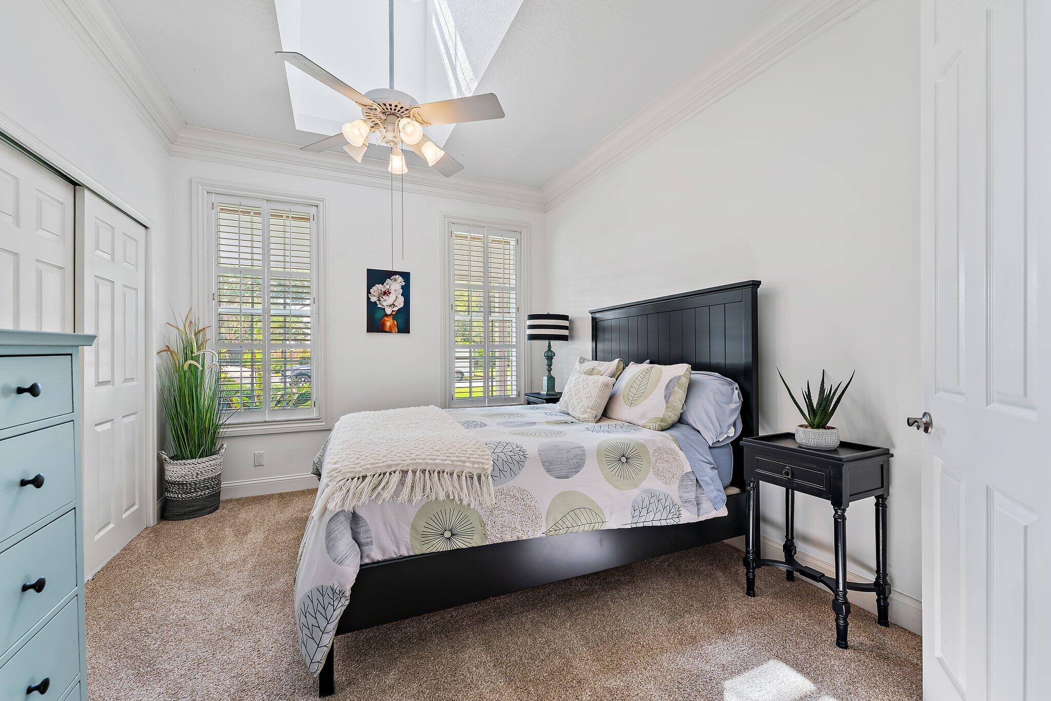 18263 River Oaks Drive Jupiter, FL 33458 - Photo 27 of 49 a bedroom with a bed chandelier and a window