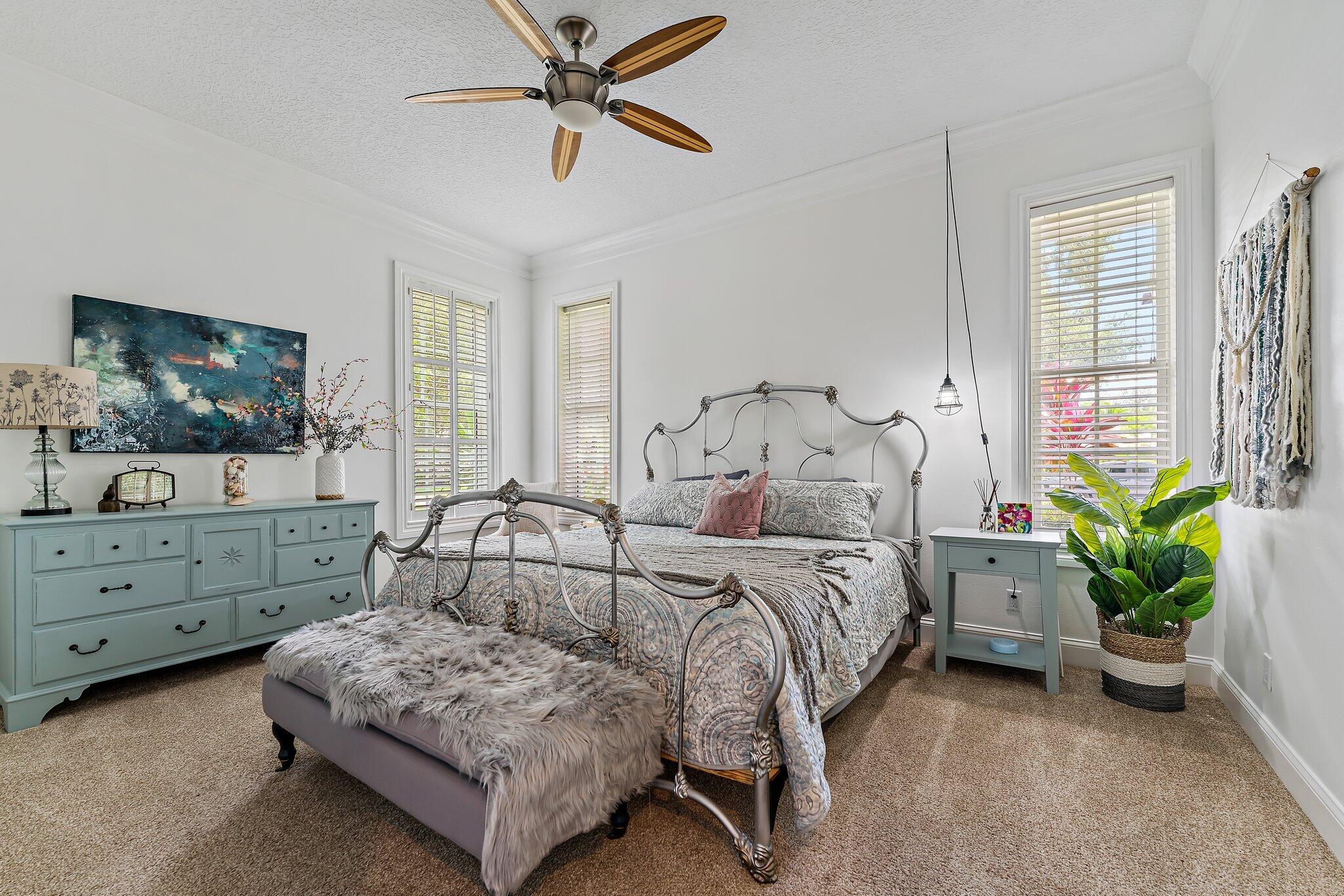 18263 River Oaks Drive Jupiter, FL 33458 - Photo 29 of 49 a bedroom with a bed and a dresser