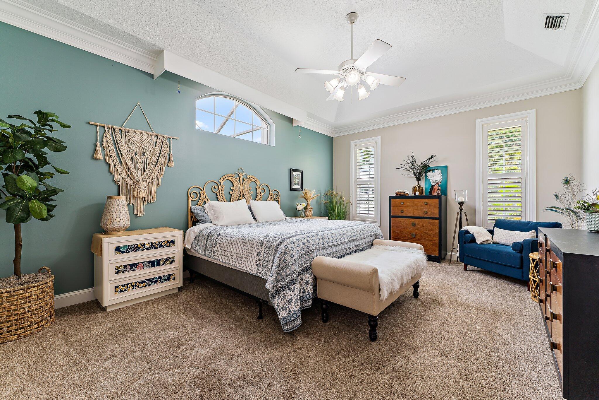 18263 River Oaks Drive Jupiter, FL 33458 - Photo 33 of 49 a bedroom with a bed and a chandelier
