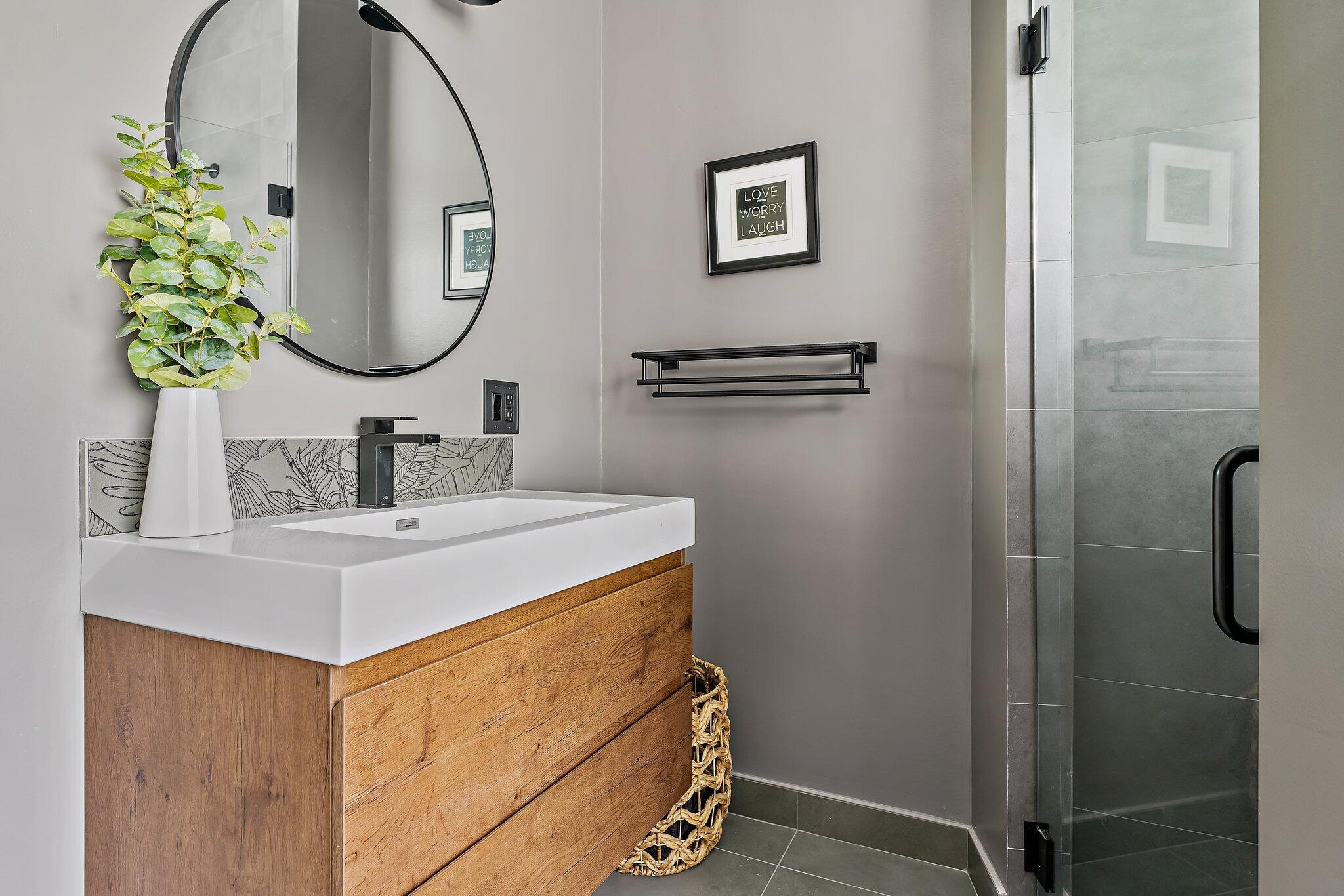 18263 River Oaks Drive Jupiter, FL 33458 - Photo 38 of 49 a bathroom with a sink and a mirror