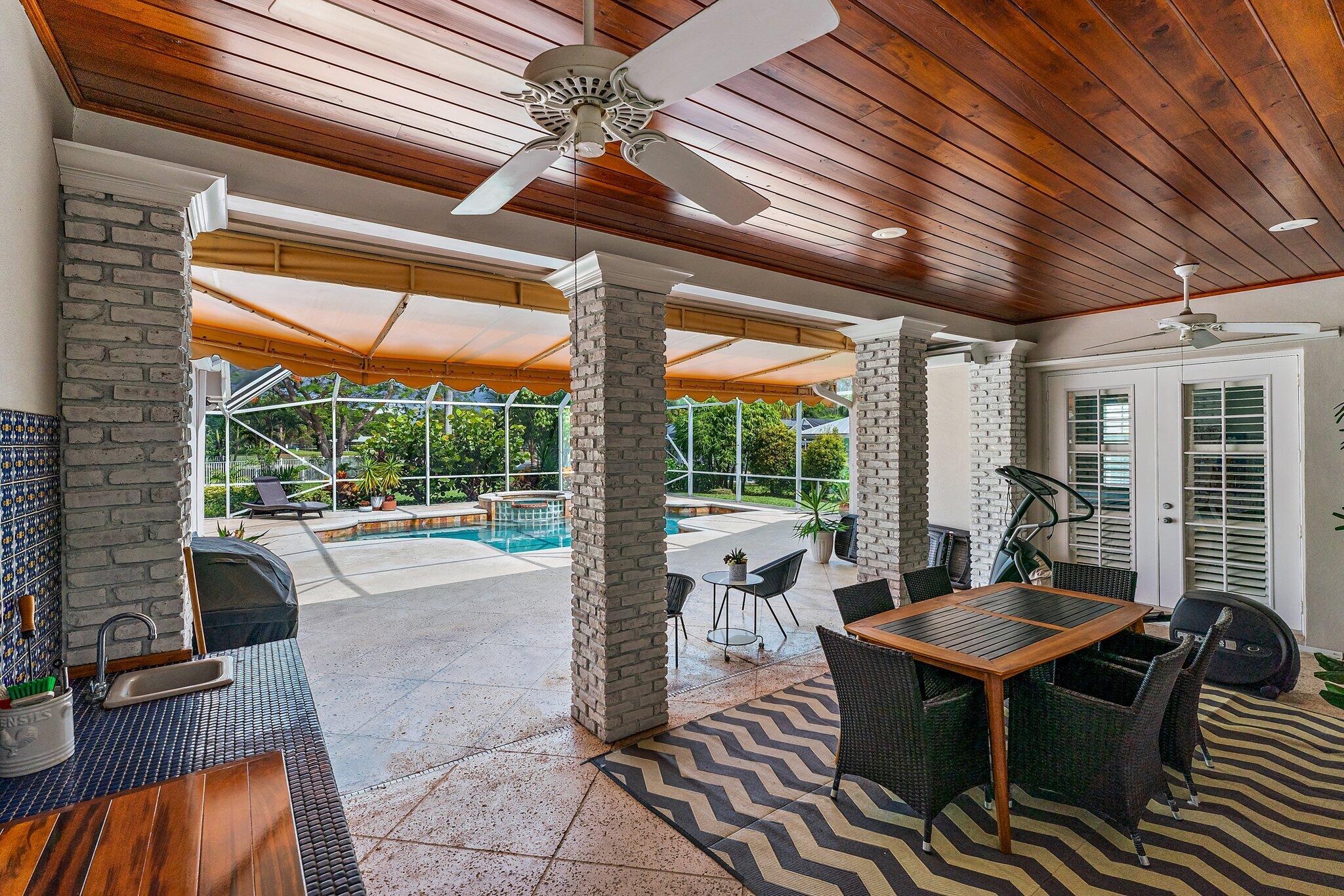 18263 River Oaks Drive Jupiter, FL 33458 - Photo 43 of 49 a view of a patio with table and chairs and potted plants