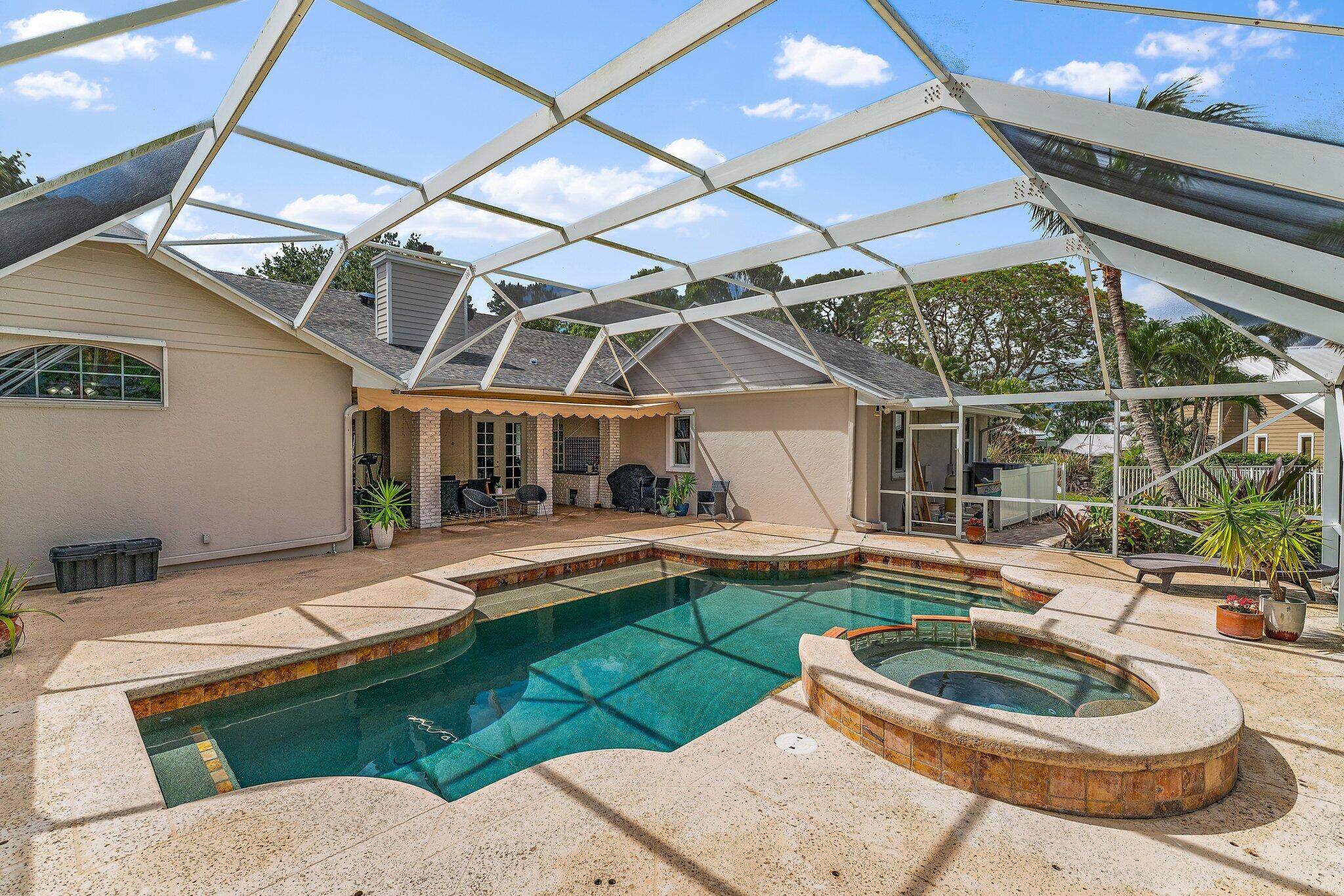 18263 River Oaks Drive Jupiter, FL 33458 - Photo 46 of 49 a patio with a table and chairs