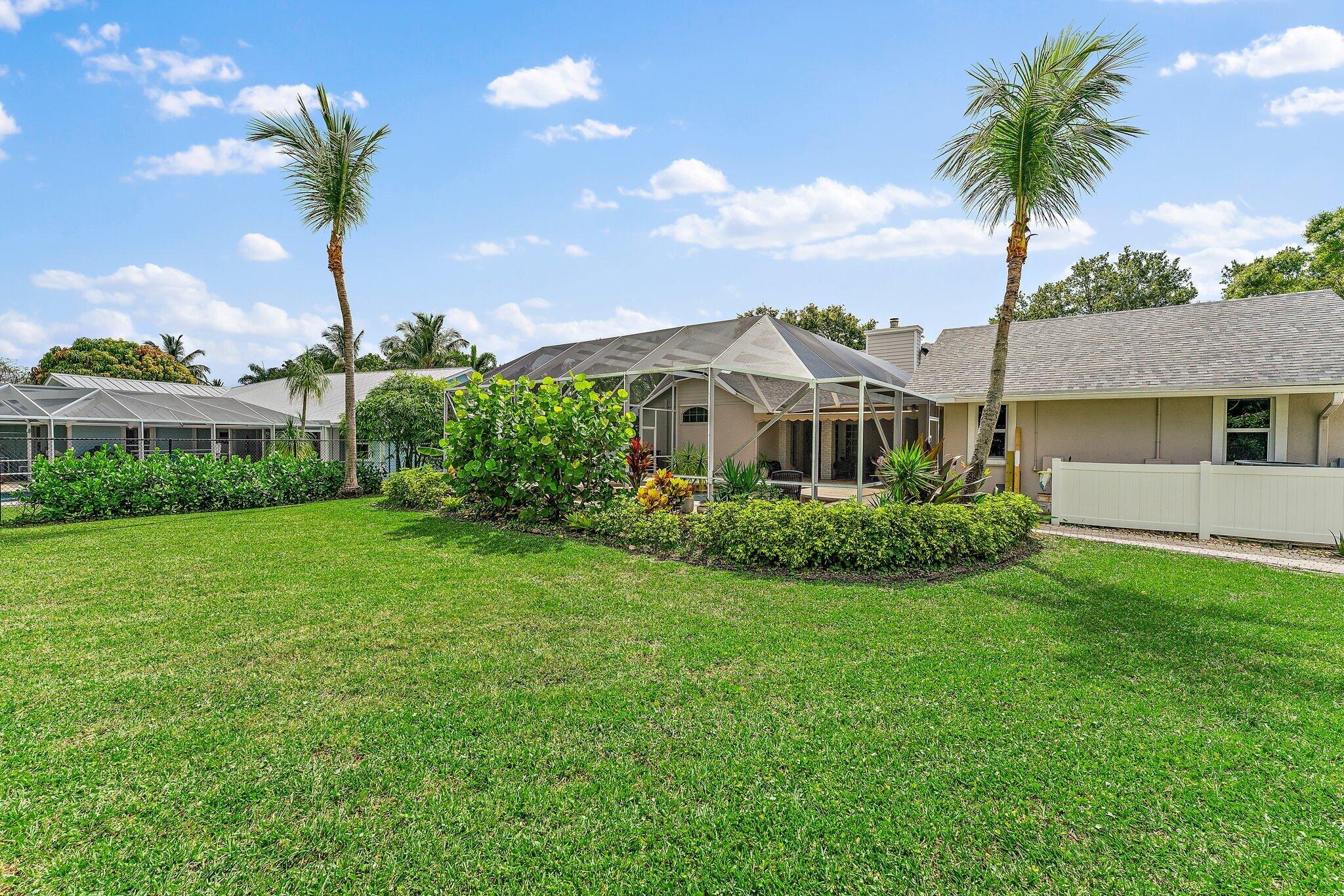 18263 River Oaks Drive Jupiter, FL 33458 - Photo 49 of 49 a front view of a house with garden