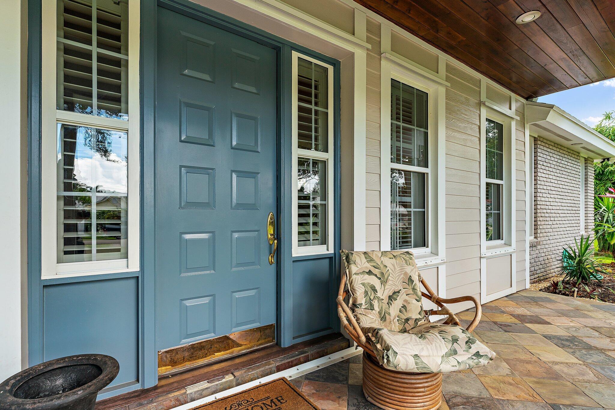 18263 River Oaks Drive Jupiter, FL 33458 - Photo 6 of 49 a front view of a house with outdoor seating