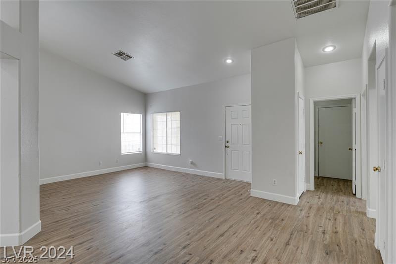 9660 Crystal Ridge Road Las Vegas, NV 89123 - Photo 5 of 18 A spacious, naturally illuminated living area with high ceilings and beautiful wood-look flooring.