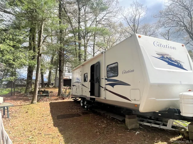 a backyard of a house with barbeque oven and outdoor seating