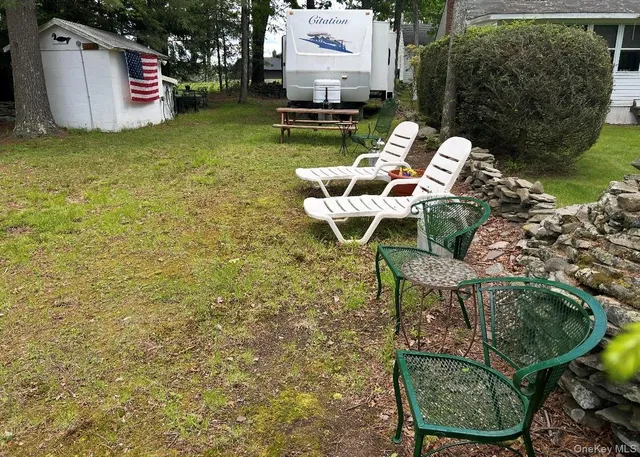 a backyard of a house with yard and outdoor seating