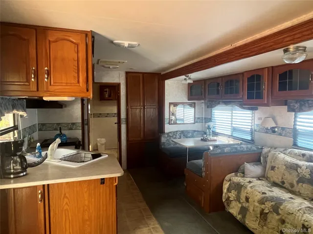a kitchen with stainless steel appliances granite countertop a sink and a refrigerator