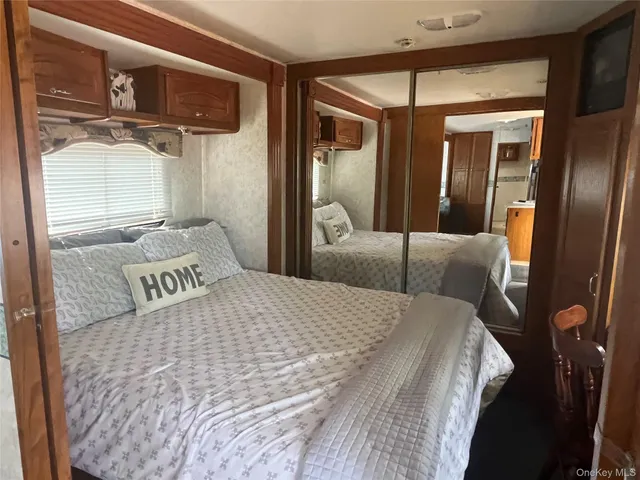 a bedroom with a bed and a mirror