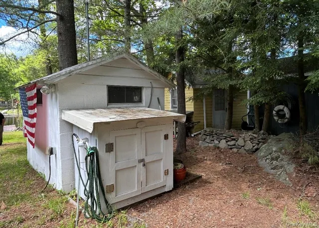 a view of a house with a yard garage and furniture