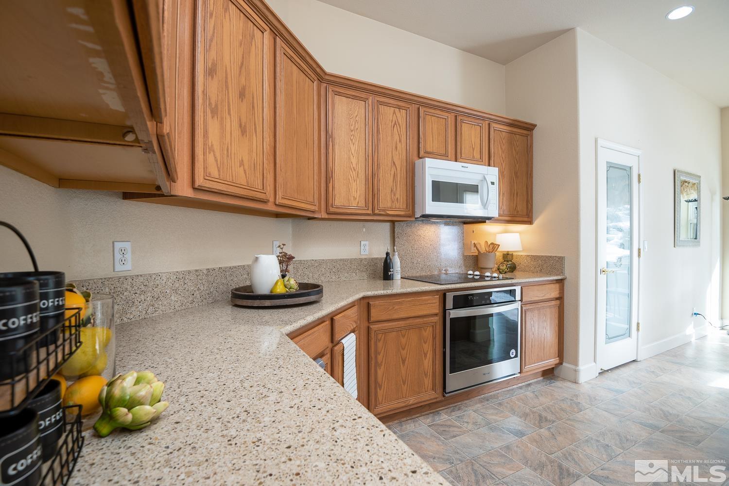 2647 Skyline Drive Minden, NV 89423 - Photo 11 of 39 a kitchen with stainless steel appliances granite countertop a stove a sink and a microwave