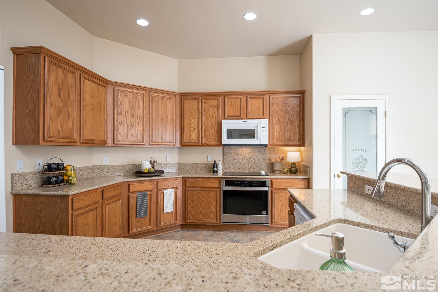 2647 Skyline Drive Minden, NV 89423 - Photo 13 of 39 a kitchen with stainless steel appliances granite countertop a sink stove and cabinets