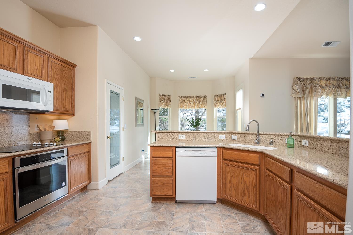 2647 Skyline Drive Minden, NV 89423 - Photo 14 of 39 a kitchen with stainless steel appliances granite countertop a stove a sink and a microwave