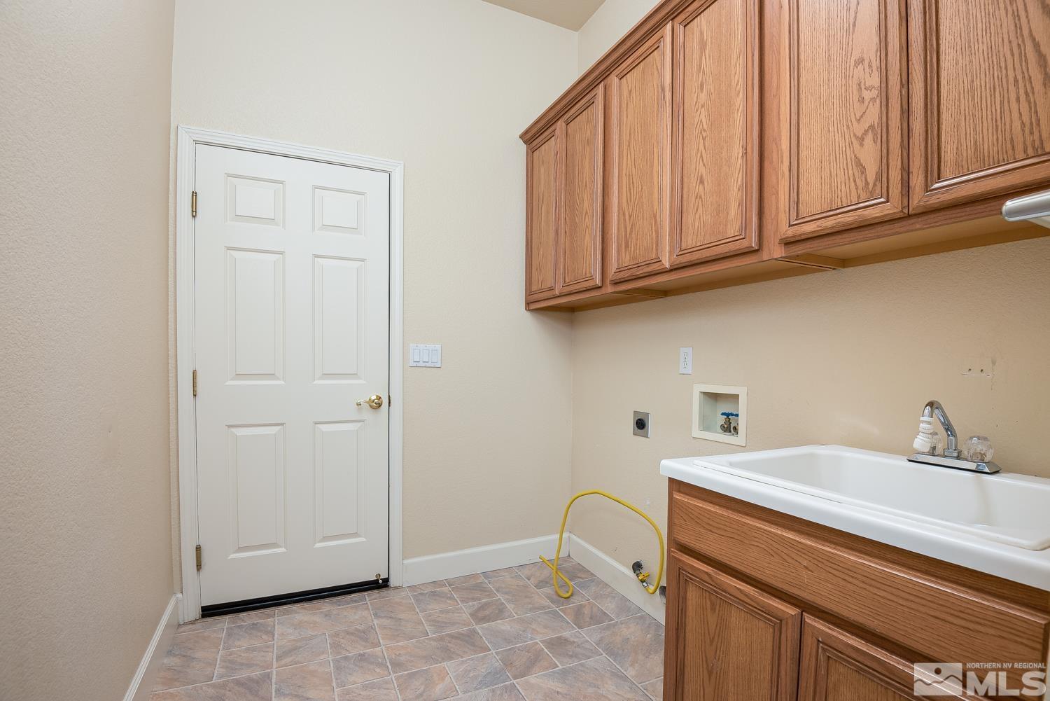 2647 Skyline Drive Minden, NV 89423 - Photo 27 of 39 a bathroom with a sink and cabinets