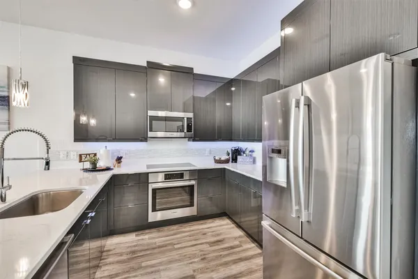 a kitchen with stainless steel appliances kitchen island granite countertop a sink and cabinets