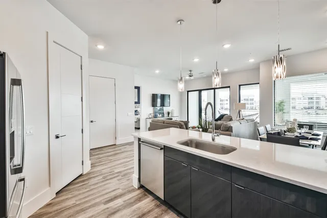 a kitchen with stainless steel appliances granite countertop a sink and stove