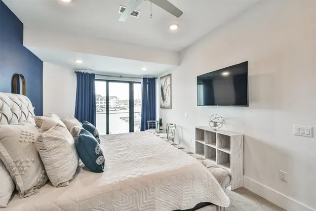 a living room with furniture and large windows