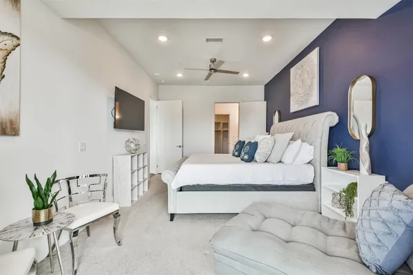 a bed room with a bed and a chair