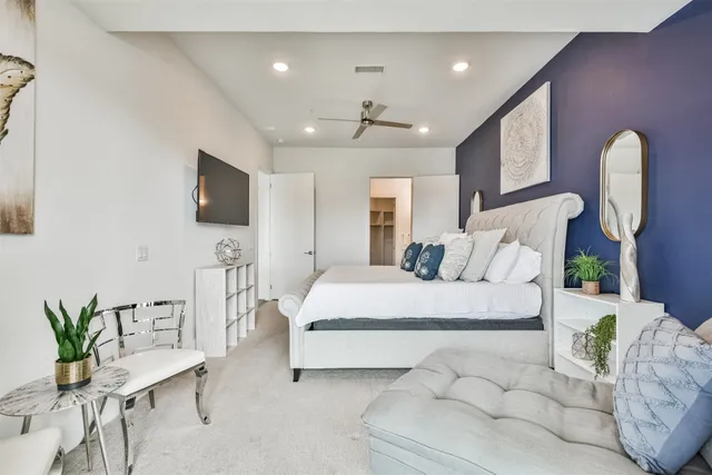 a bed room with a bed and a chair