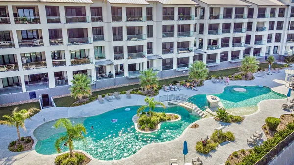 a view of hallway with furniture and floor to ceiling window
