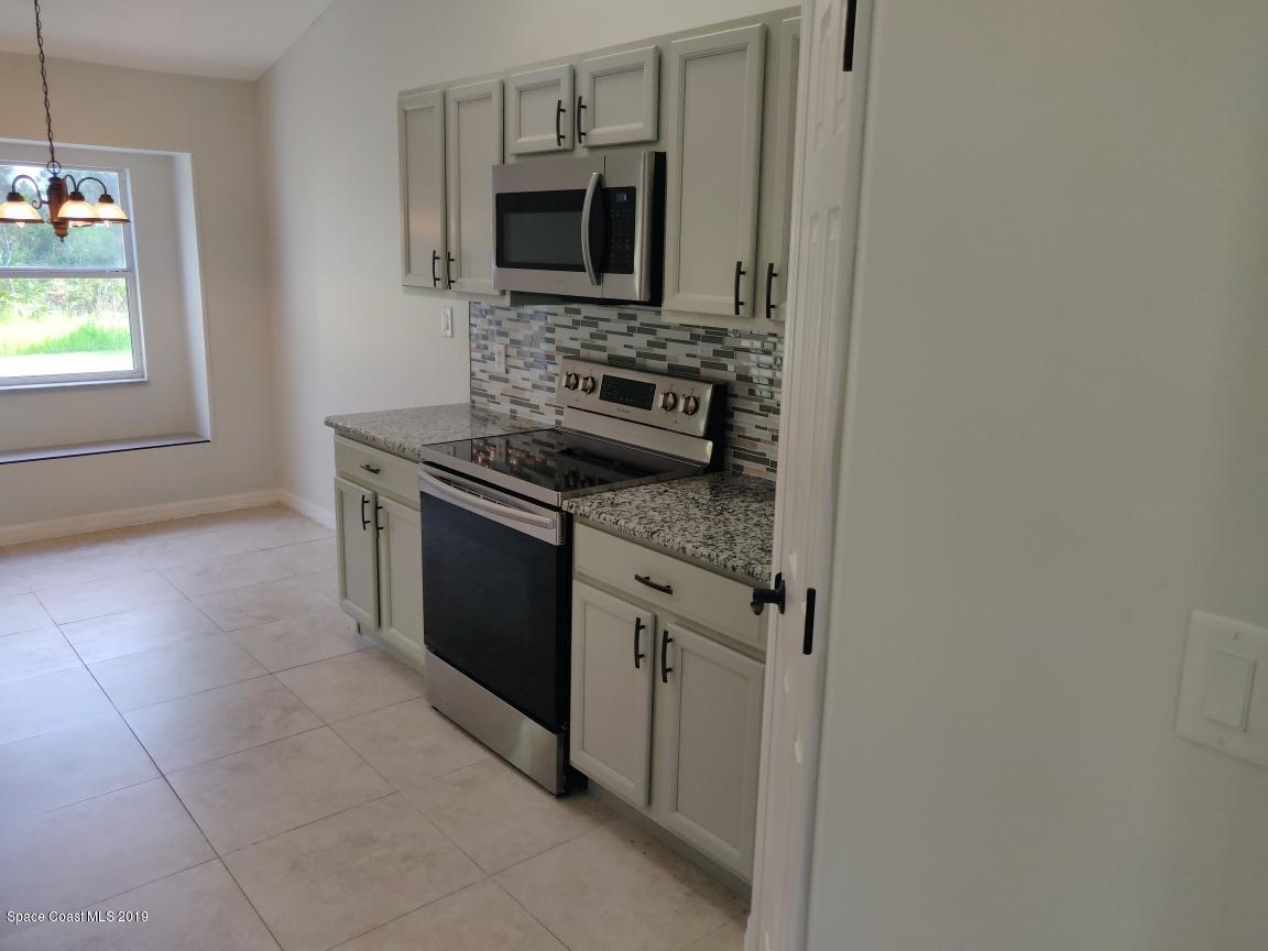 2025 Benjamin Road Grant Valkaria, FL 32950 - Photo 14 of 40 a kitchen with a stove and a microwave