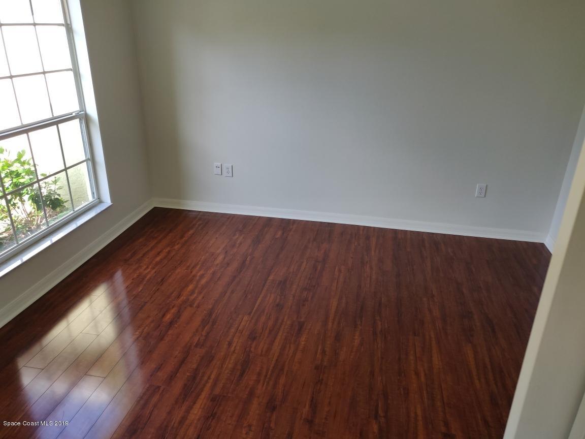 2025 Benjamin Road Grant Valkaria, FL 32950 - Photo 20 of 40 an empty room with wooden floor and windows