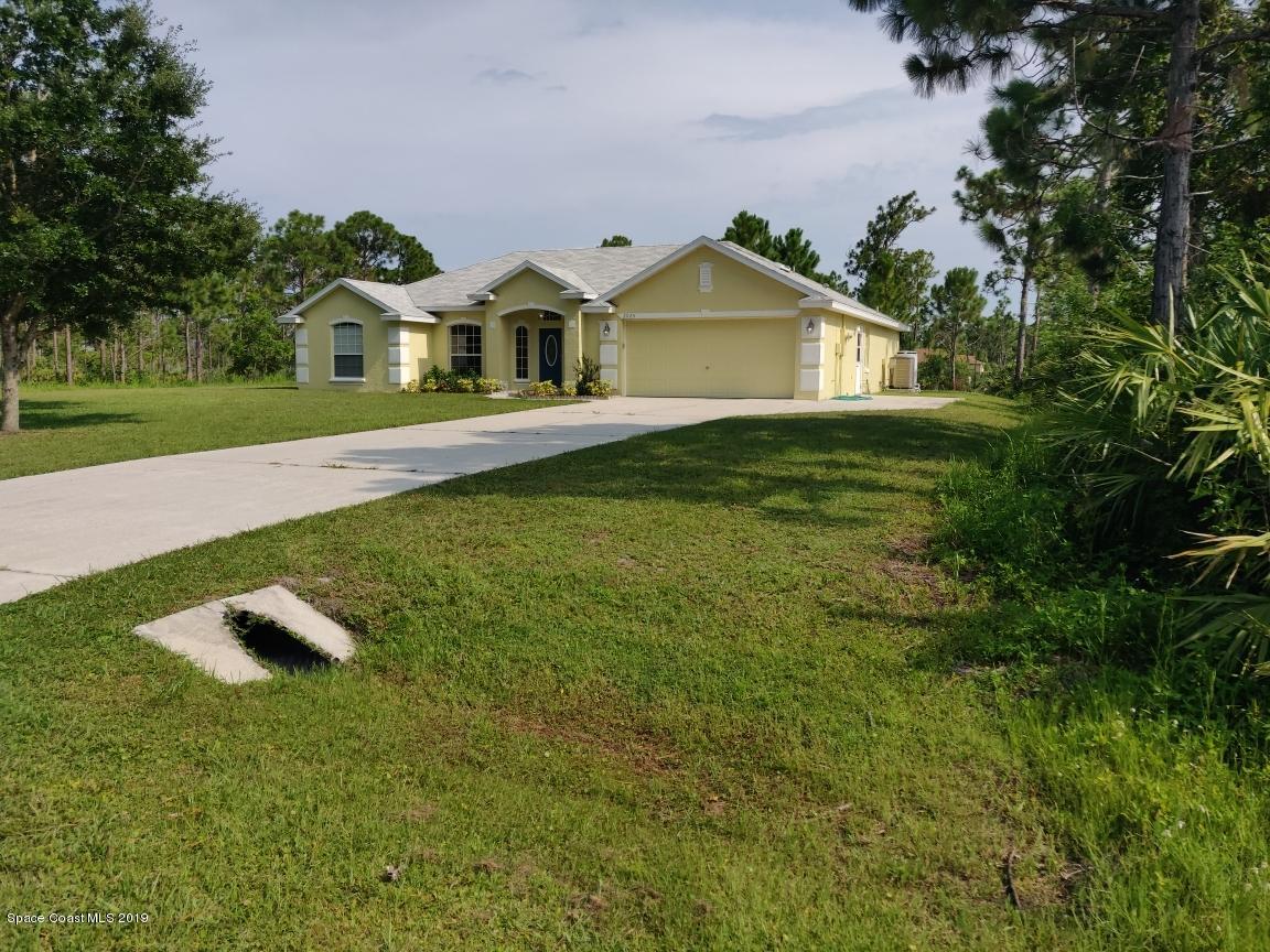 2025 Benjamin Road Grant Valkaria, FL 32950 - Photo 3 of 40 a front view of a house with garden