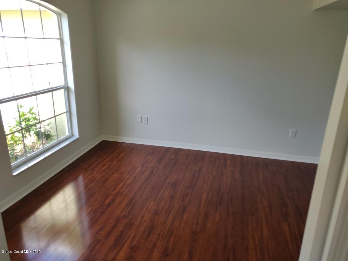 2025 Benjamin Road Grant Valkaria, FL 32950 - Photo 21 of 40 an empty room with wooden floor and windows