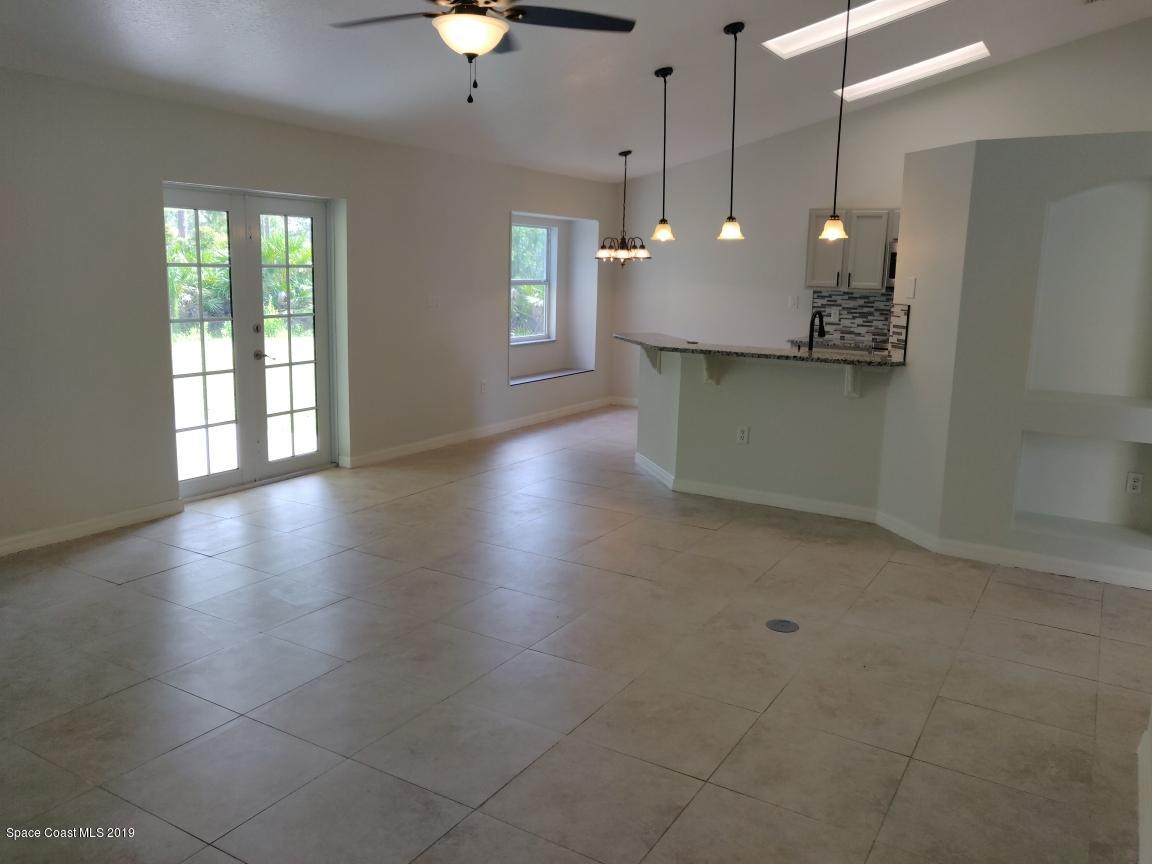 2025 Benjamin Road Grant Valkaria, FL 32950 - Photo 23 of 40 a view of a kitchen with a refrigerator and a window