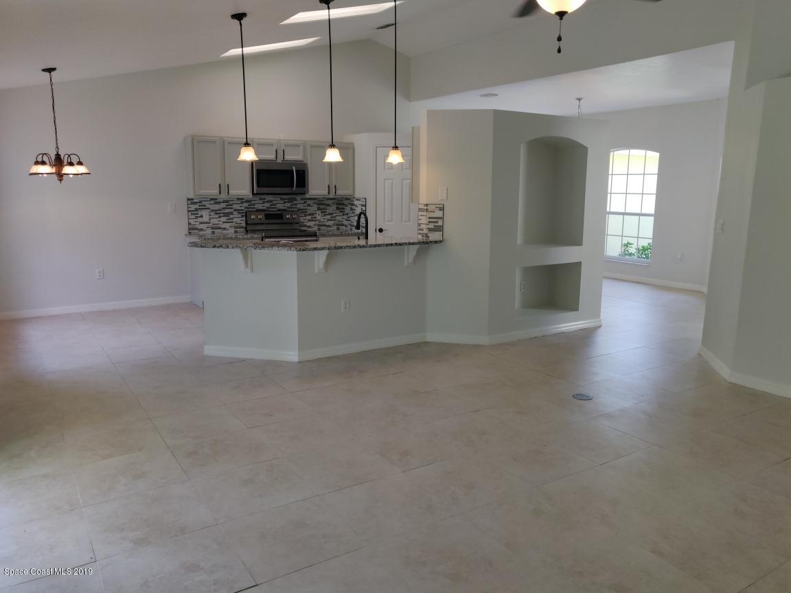 2025 Benjamin Road Grant Valkaria, FL 32950 - Photo 24 of 40 a view of a kitchen with a sink and chandelier