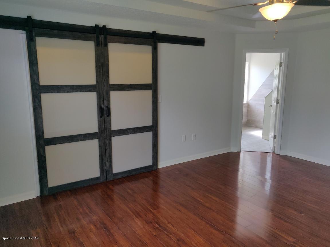 2025 Benjamin Road Grant Valkaria, FL 32950 - Photo 26 of 40 a view of a big room with wooden floor