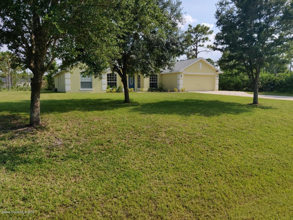 2025 Benjamin Road Grant Valkaria, FL 32950 - Photo 4 of 40 a front view of a house with garden