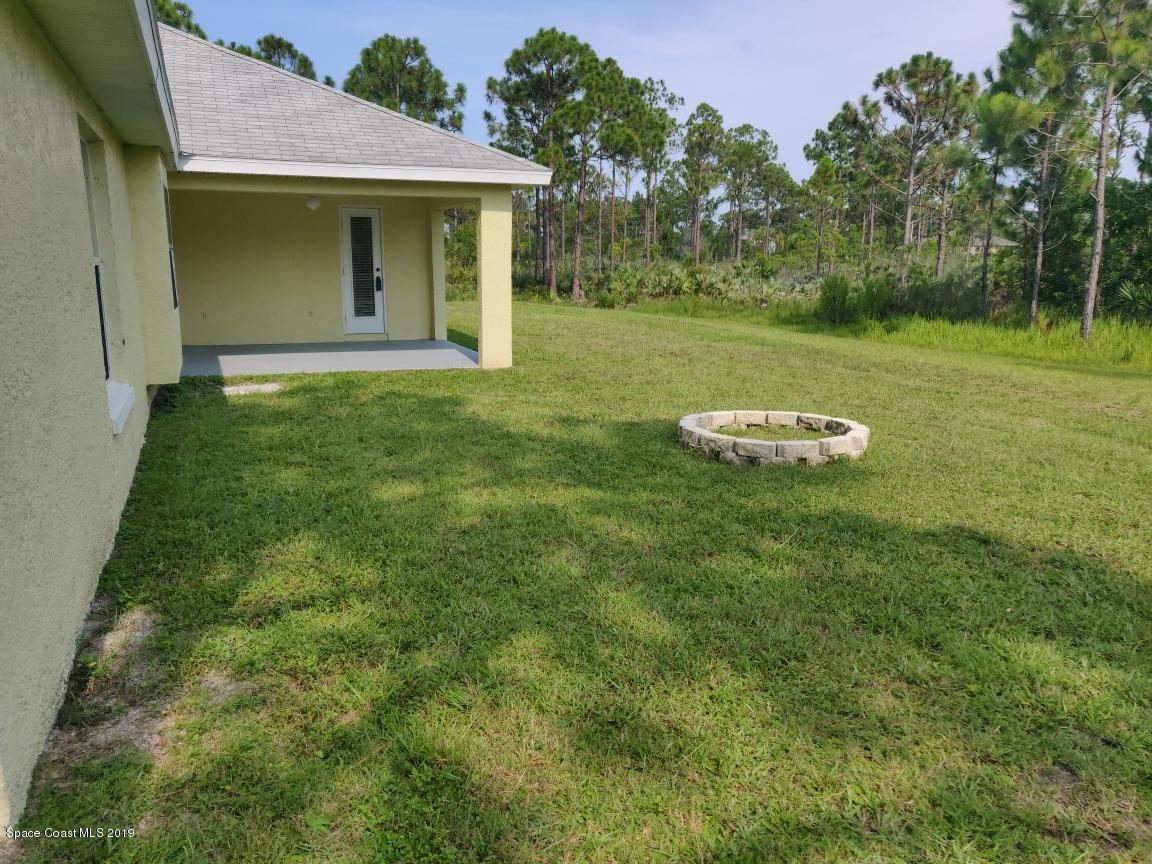 2025 Benjamin Road Grant Valkaria, FL 32950 - Photo 7 of 40 a front view of a house with a yard