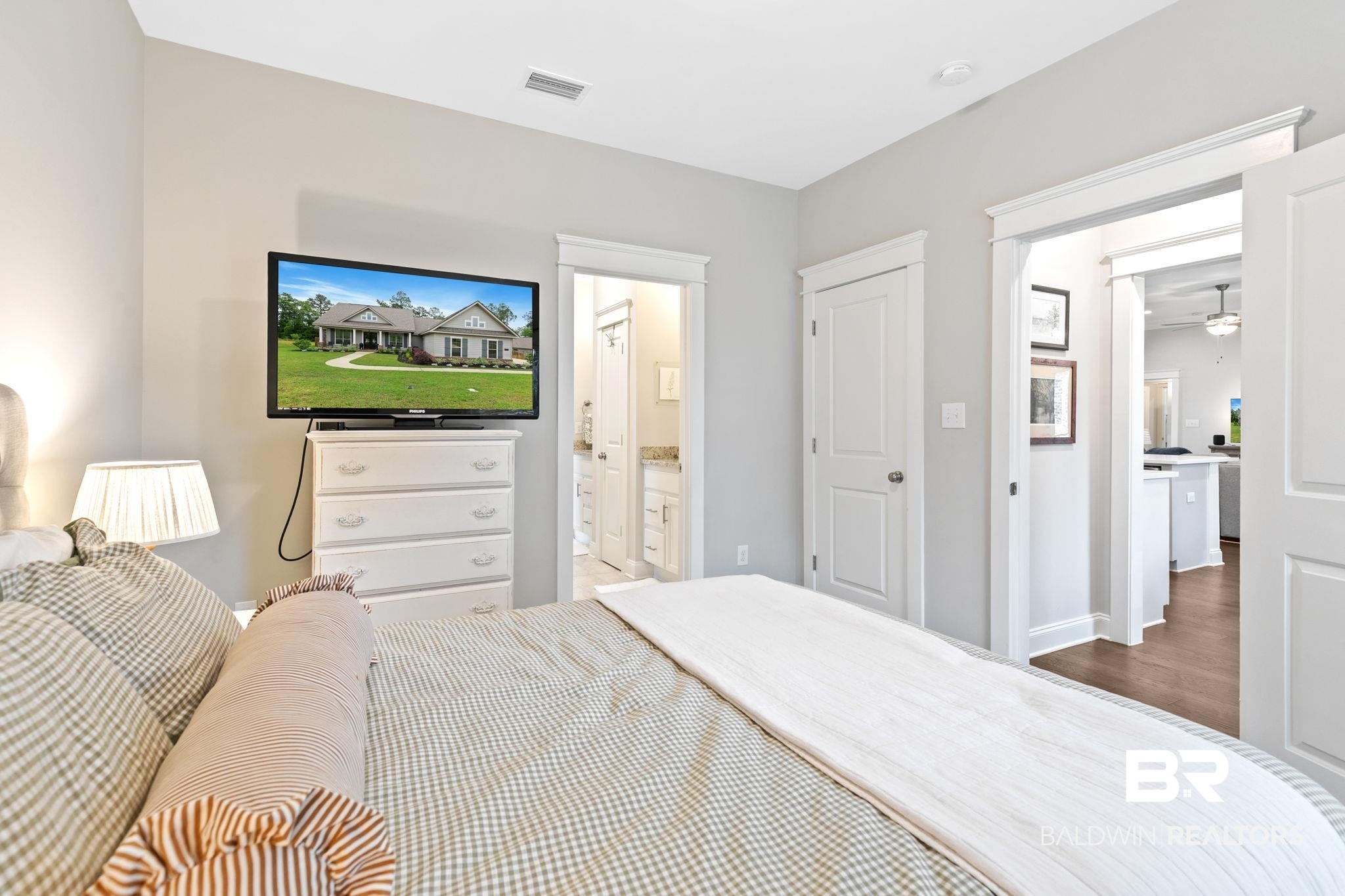 13233 Ibis Boulevard Daphne, AL 36527 - Photo 48 of 100 Bedroom featuring light gray walls, white trim, and a doorway opening to a bathroom with a dual vanity