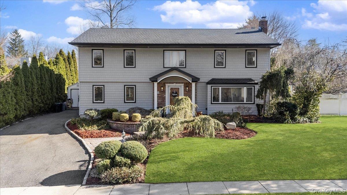 98 Barry Lane Syosset, NY 11791 - Photo 1 of 43 a front view of a house with garden