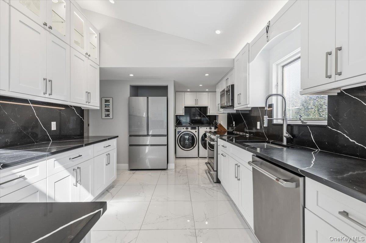 98 Barry Lane Syosset, NY 11791 - Photo 14 of 43 a large kitchen with stainless steel appliances lots of counter space and a sink