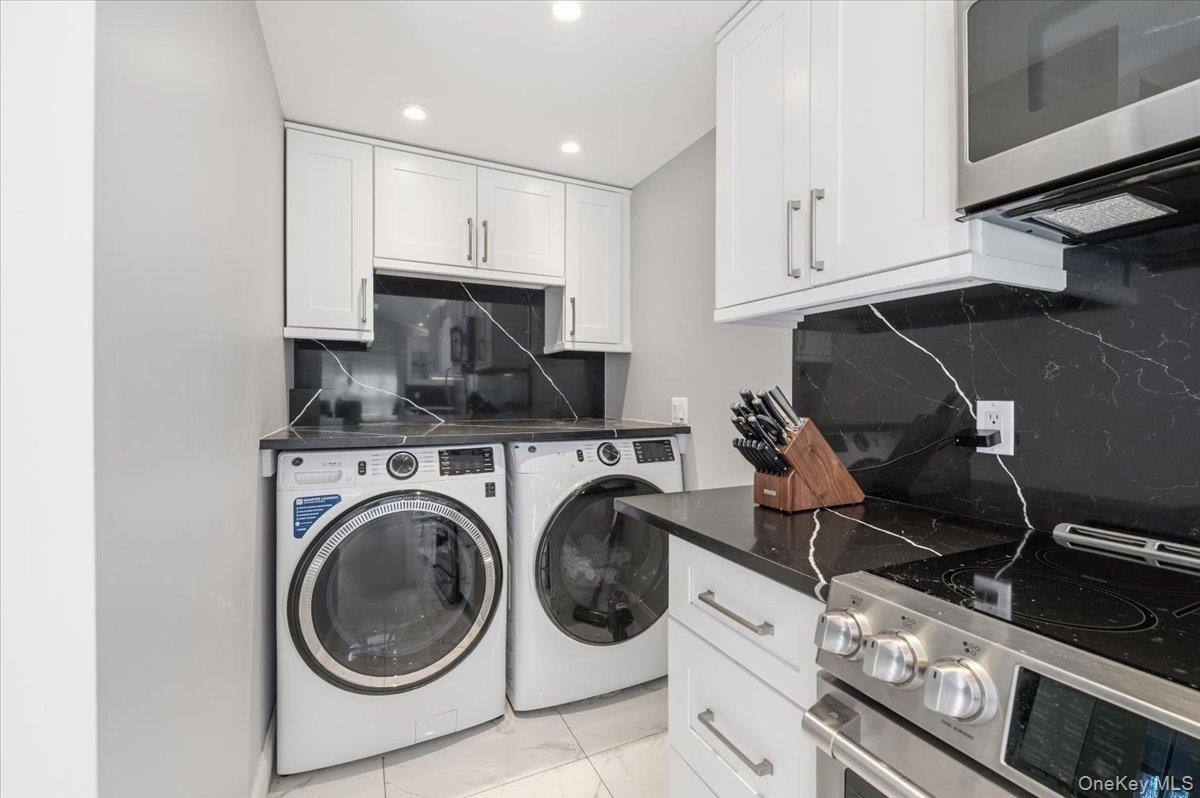 98 Barry Lane Syosset, NY 11791 - Photo 16 of 43 a utility room with sink dryer and washer