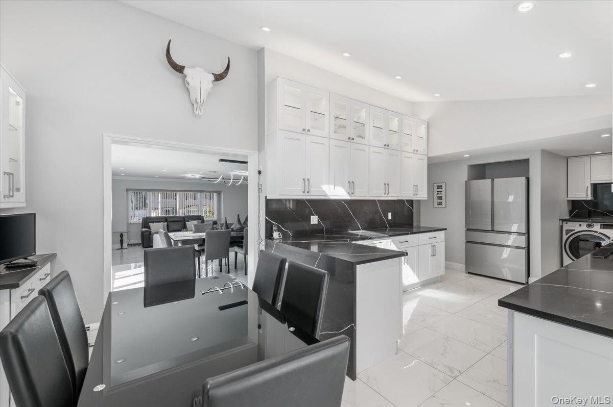 98 Barry Lane Syosset, NY 11791 - Photo 17 of 43 a kitchen with stainless steel appliances granite countertop a sink refrigerator and cabinets