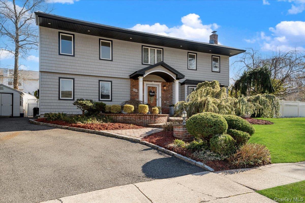 98 Barry Lane Syosset, NY 11791 - Photo 2 of 43 a front view of a house with a yard