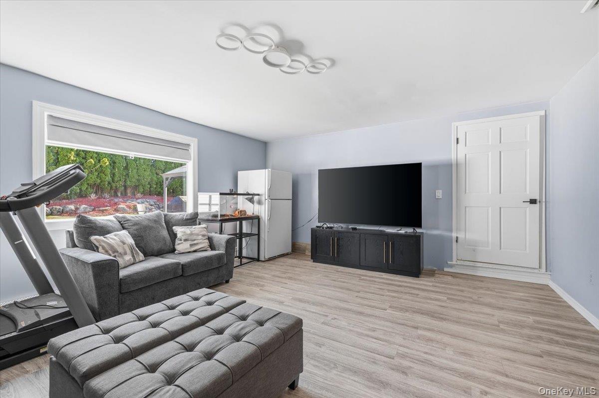 98 Barry Lane Syosset, NY 11791 - Photo 21 of 43 a living room with furniture and a flat screen tv