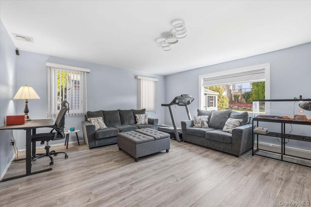98 Barry Lane Syosset, NY 11791 - Photo 22 of 43 a living room with furniture and wooden floor