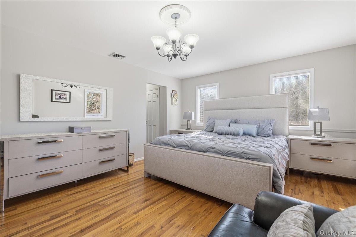 98 Barry Lane Syosset, NY 11791 - Photo 28 of 43 a spacious bedroom with a bed and window