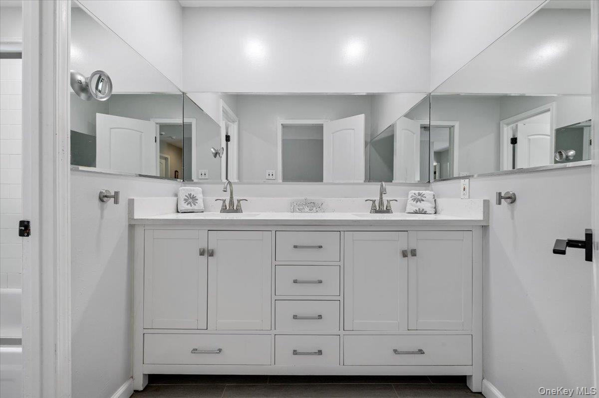 98 Barry Lane Syosset, NY 11791 - Photo 33 of 43 a bathroom with a sink double vanity and a mirror