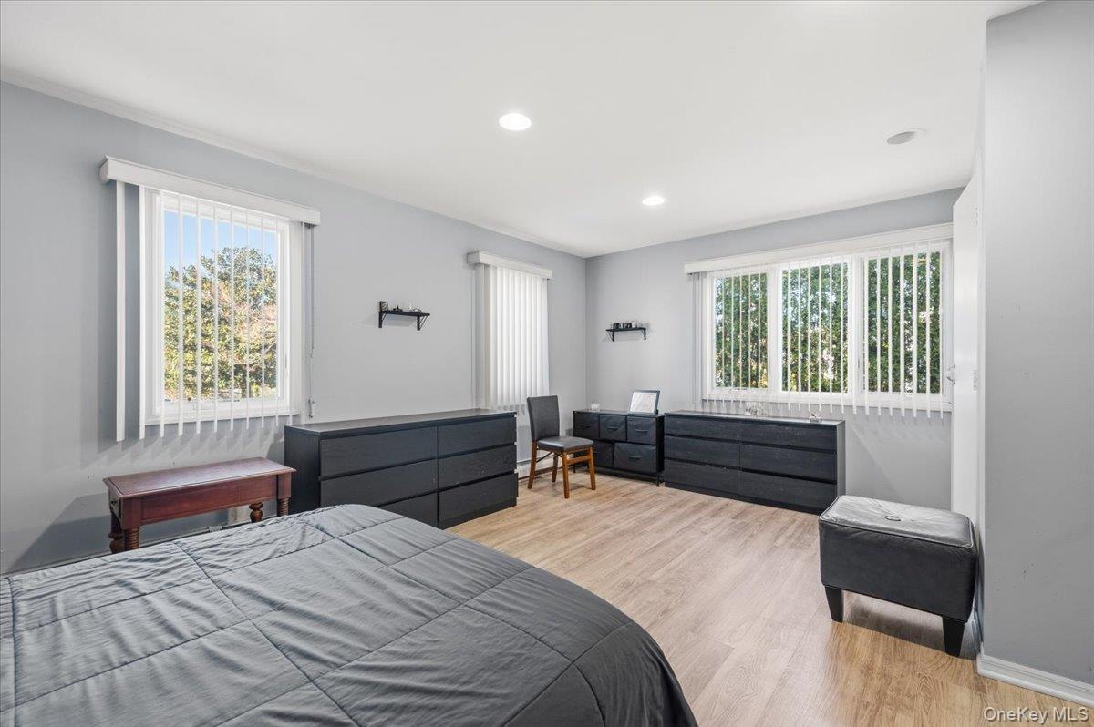 98 Barry Lane Syosset, NY 11791 - Photo 36 of 43 a bedroom with a bed and a window