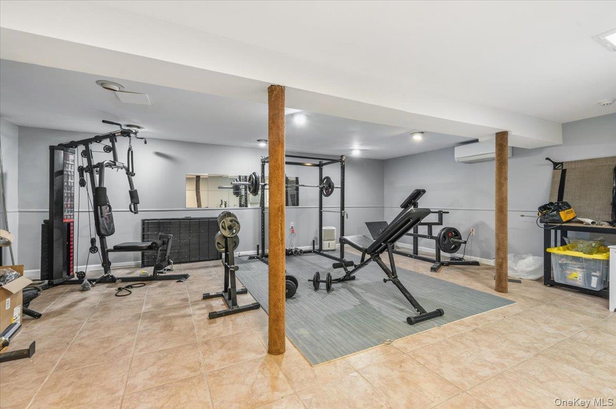98 Barry Lane Syosset, NY 11791 - Photo 38 of 43 a view of a room with gym equipment