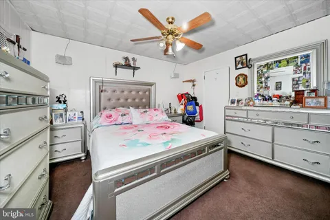 a bedroom with a bed and a gym machine