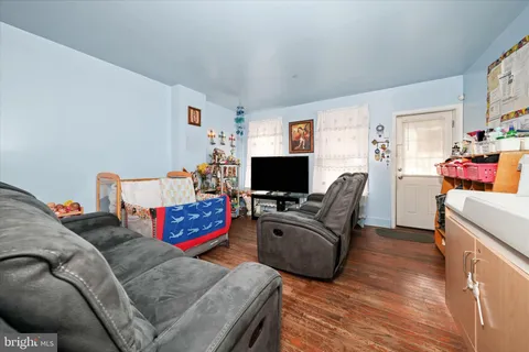a living room with furniture and a baby crib