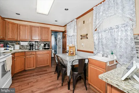 a kitchen with stainless steel appliances granite countertop a stove refrigerator sink and cabinets