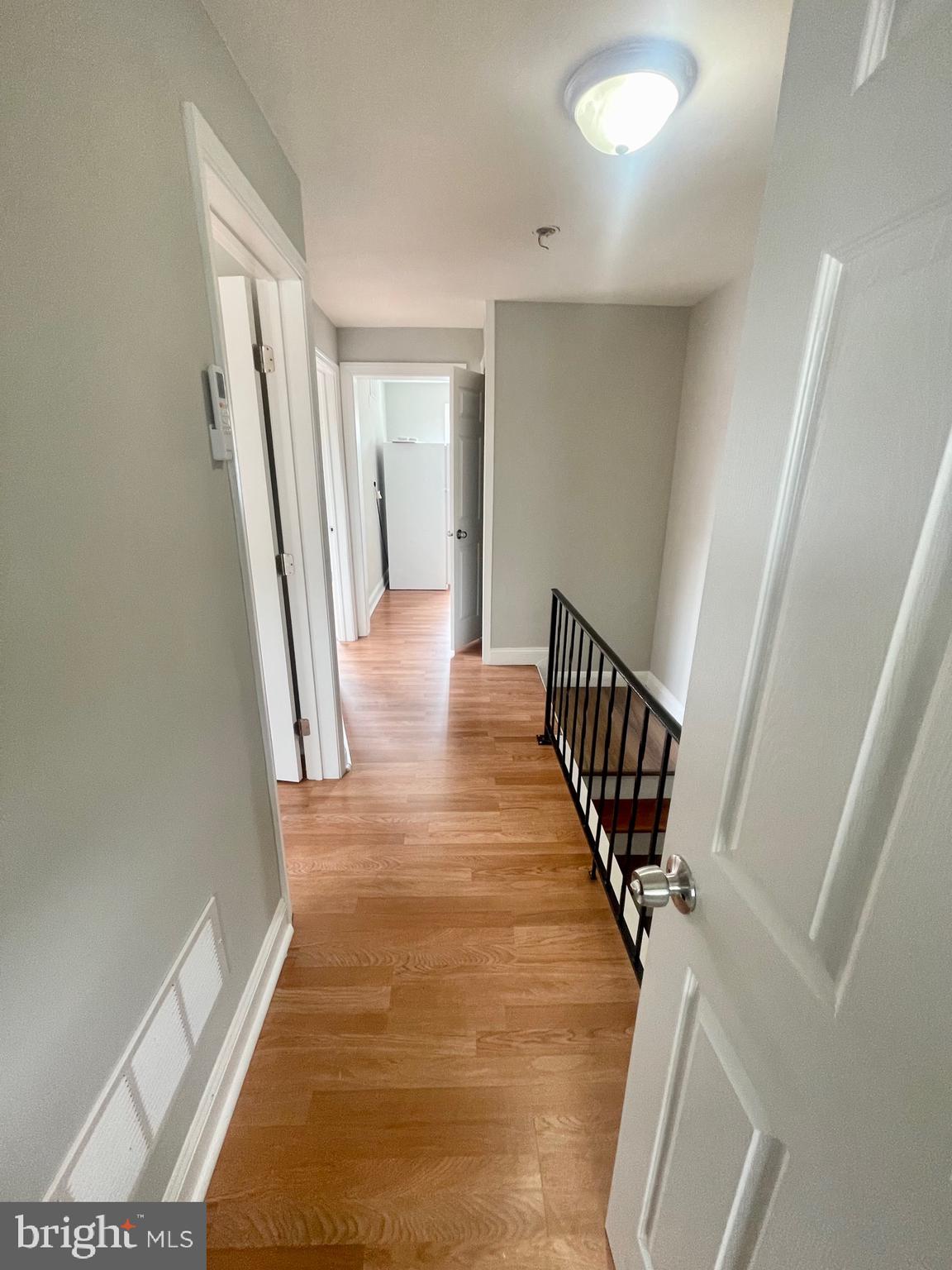 8528 Chestnut Oak Road, Unit B Baltimore, MD 21234 - Photo 12 of 15 a view of a hallway with wooden floor and stairs