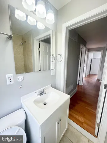 a bathroom with a sink a toilet and a mirror